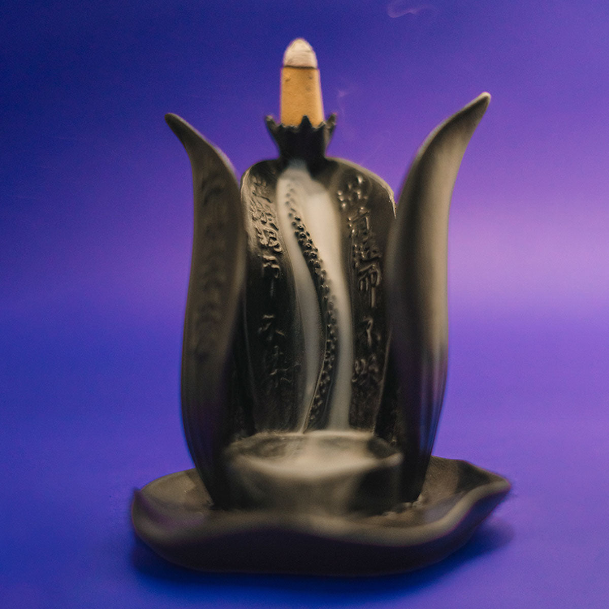 Incensário Lótus de Buda em cerâmica preta, com efeito de fluxo reverso da fumaça, trazendo harmonia e paz ao ambiente Pelicano Azul.