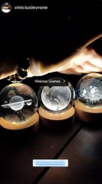 Avaliação de cliente mostrando três luminárias planetárias acesas, projetando luzes que representam planetas e o universo