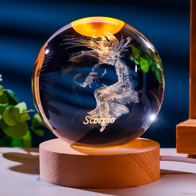 Luminária de cristal com o signo de escorpião gravado em 3D, iluminada por LED, criando um efeito celestial. Ideal para representar o equilíbrio e a harmonia do signo de Escorpião. Pelicano Azul.