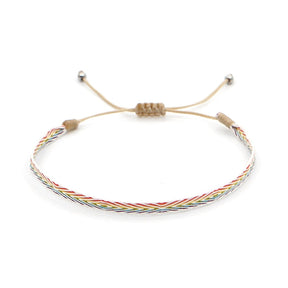 Bracelete ajustável de fio colorido com padrão trançado, parte do Conjunto Budista da Amizade, com estilo minimalista e espiritual, Pelicano Azul.