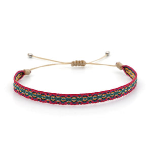 Pulseira ajustável com padrão colorido em verde e vermelho, parte do Conjunto Budista da Coragem, Pelicano Azul.
